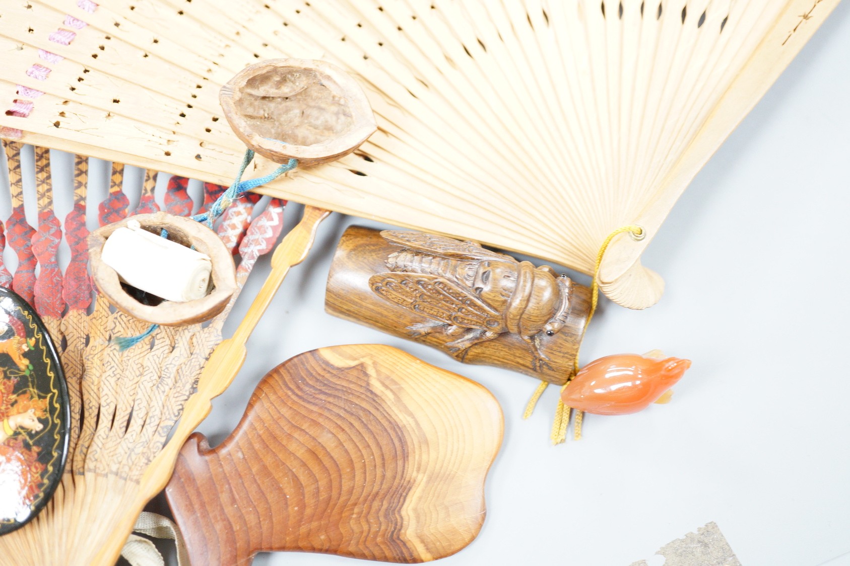 A Japanese hardwood cicada netsuke, two hardstone pieces and sundries
